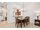 Formal dining room features a dark wood table and six chairs, open to other rooms with white walls at 3205 Bailey Ann Dr, Ormond Beach, FL 32174