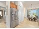 Kitchen with stainless steel refrigerator, tile floors and an adjacent breakfast nook at 3205 Bailey Ann Dr, Ormond Beach, FL 32174