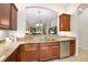 Open kitchen featuring wood cabinets, granite counters, and stainless steel appliances at 3205 Bailey Ann Dr, Ormond Beach, FL 32174