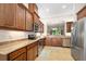 Well-equipped kitchen featuring wood cabinets, granite counters, and stainless steel appliances at 3205 Bailey Ann Dr, Ormond Beach, FL 32174
