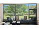 Inviting screened lanai with cozy seating, perfect for enjoying the beautiful views of the golf course at 3205 Bailey Ann Dr, Ormond Beach, FL 32174