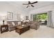Cozy living room features two sofas, a coffee table, and sliding glass doors leading to an outdoor area at 3205 Bailey Ann Dr, Ormond Beach, FL 32174