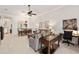 Open-concept living room and dining area, featuring neutral tones, a ceiling fan, and stylish furnishings at 3205 Bailey Ann Dr, Ormond Beach, FL 32174
