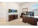 Functional home office space with a modern desk setup, large TV, and plenty of storage for productivity at 3205 Bailey Ann Dr, Ormond Beach, FL 32174