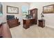Professional home office featuring a large desk, printer, and stylish decor for an efficient work environment at 3205 Bailey Ann Dr, Ormond Beach, FL 32174