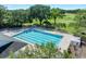 Community pool and lounge area with mature trees and landscaping at 3205 Bailey Ann Dr, Ormond Beach, FL 32174