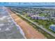 Scenic aerial view of beachfront condos, showcasing ocean frontage and the surrounding neighborhood at 3370 Ocean Shore Blvd # 206B, Ormond Beach, FL 32176