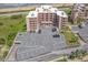 Aerial view of complex with parking and a view of the ocean at 3370 Ocean Shore Blvd # 206B, Ormond Beach, FL 32176