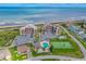 Aerial view showcases a beachfront condo with a community pool, tennis court, and oceanfront parking at 3370 Ocean Shore Blvd # 206B, Ormond Beach, FL 32176