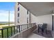 Spacious balcony with ocean views featuring a black metal guardrail and patio furniture at 3370 Ocean Shore Blvd # 206B, Ormond Beach, FL 32176