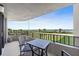 Spacious balcony with ocean views featuring a black metal guardrail and patio furniture at 3370 Ocean Shore Blvd # 206B, Ormond Beach, FL 32176