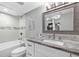 Well-lit bathroom featuring a shower-tub combination, granite countertops, and stylish fixtures at 3370 Ocean Shore Blvd # 206B, Ormond Beach, FL 32176