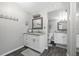 Bright bathroom featuring a dual sink vanity with a granite countertop and wooden floors at 3370 Ocean Shore Blvd # 206B, Ormond Beach, FL 32176
