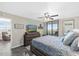 Comfortable bedroom features a ceiling fan, tv, and access to a patio overlooking the ocean at 3370 Ocean Shore Blvd # 206B, Ormond Beach, FL 32176