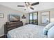 Comfortable bedroom features a ceiling fan, tv, and access to a patio overlooking the ocean at 3370 Ocean Shore Blvd # 206B, Ormond Beach, FL 32176