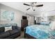 Comfortable bedroom with coastal decor, ceiling fan, and a mirrored closet at 3370 Ocean Shore Blvd # 206B, Ormond Beach, FL 32176