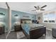 Well-lit bedroom featuring a ceiling fan, light blue walls, and hardwood floors at 3370 Ocean Shore Blvd # 206B, Ormond Beach, FL 32176
