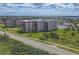 Exterior shot of a beachfront condo building with private balconies and well-maintained landscaping at 3370 Ocean Shore Blvd # 206B, Ormond Beach, FL 32176