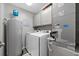 Laundry room features washer, dryer, cabinets, and water heater at 3370 Ocean Shore Blvd # 206B, Ormond Beach, FL 32176