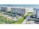 Stunning aerial view of a beachfront condo building with lush landscaping and private beach access at 4631 S Atlantic Ave # 8706, Ponce Inlet, FL 32127