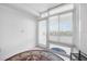 Sunlit room featuring a large window with blinds and a door to the balcony at 4631 S Atlantic Ave # 8706, Ponce Inlet, FL 32127