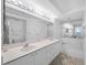 Bright bathroom featuring double sinks, bright vanity lighting, a shower, and soaking tub at 4631 S Atlantic Ave # 8706, Ponce Inlet, FL 32127