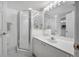 Bright bathroom with a glass-enclosed shower and a white vanity with sink, and mirror at 4631 S Atlantic Ave # 8706, Ponce Inlet, FL 32127