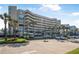 Exterior view of the building with palm trees and parking at 4631 S Atlantic Ave # 8706, Ponce Inlet, FL 32127