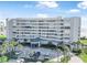 Beautiful condominium building with a grand entrance, lush landscaping, and convenient parking at 4631 S Atlantic Ave # 8706, Ponce Inlet, FL 32127