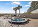 Relaxing community hot tub with lounge seating and palm trees, perfect for enjoying the Florida sunshine at 4631 S Atlantic Ave # 8706, Ponce Inlet, FL 32127