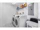 The laundry room has a washer, dryer, and shelving for storage at 4631 S Atlantic Ave # 8706, Ponce Inlet, FL 32127