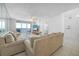 Beautifully lit living room with ocean view and access to the balcony at 4631 S Atlantic Ave # 8706, Ponce Inlet, FL 32127
