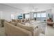 Bright and airy living room with ocean views, ceiling fan, tile floors, and sliding glass doors to the balcony at 4631 S Atlantic Ave # 8706, Ponce Inlet, FL 32127