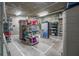 Storage area with a concrete floor and block wall with various shelving units and items at 4631 S Atlantic Ave # 8706, Ponce Inlet, FL 32127