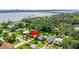 Aerial view of charming home near the water featuring mature trees, and well-maintained lawn at 48 Rosewood Ave, Ormond Beach, FL 32174