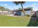 Fenced backyard with a small patio, offers privacy and an area for outdoor lounging and entertaining at 48 Rosewood Ave, Ormond Beach, FL 32174