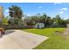 Expansive backyard with a large shed and a concrete pad, perfect for outdoor activities and storage at 48 Rosewood Ave, Ormond Beach, FL 32174