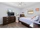 Cozy bedroom with a ceiling fan, dresser, and comfortable furnishings at 48 Rosewood Ave, Ormond Beach, FL 32174