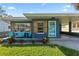 Charming home with a blue exterior, inviting front porch, and well-maintained lawn at 48 Rosewood Ave, Ormond Beach, FL 32174