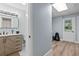 Finished basement hallway connecting a stylish bathroom with a laundry/workout area at 48 Rosewood Ave, Ormond Beach, FL 32174