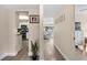 Hallway view connecting the kitchen to the living room, showcasing the open floor plan and natural light at 48 Rosewood Ave, Ormond Beach, FL 32174