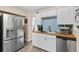 Modern kitchen featuring stainless steel appliances, white cabinets, and wood countertops at 48 Rosewood Ave, Ormond Beach, FL 32174