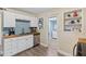 Bright kitchen featuring white cabinets, stainless steel appliances, and access to the laundry room at 48 Rosewood Ave, Ormond Beach, FL 32174