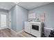 Well-lit laundry room with modern appliances, storage, and access to the outdoors at 48 Rosewood Ave, Ormond Beach, FL 32174