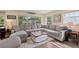 Open living room with a large sectional sofa, natural light, and a decorative 'Beach House' sign at 48 Rosewood Ave, Ormond Beach, FL 32174