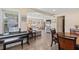 Bright and open living room featuring a piano, wood floors, and cozy seating arrangement, perfect for entertaining at 48 Rosewood Ave, Ormond Beach, FL 32174