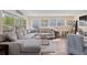 Comfortable living room featuring a large sectional sofa, wood-look floors, and ample natural light at 48 Rosewood Ave, Ormond Beach, FL 32174