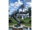 Charming park featuring a turtle statue, gazebo, flag, palm trees, and waterfront view creating an inviting outdoor space at 48 Rosewood Ave, Ormond Beach, FL 32174