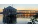 Stunning waterfront property at sunset, featuring a unique house on stilts with beautiful reflections in the water at 48 Rosewood Ave, Ormond Beach, FL 32174