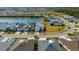Aerial view of several single-Gathering homes along a small lake with palm trees and manicured lawns at 540 Good Life Way, Daytona Beach, FL 32124